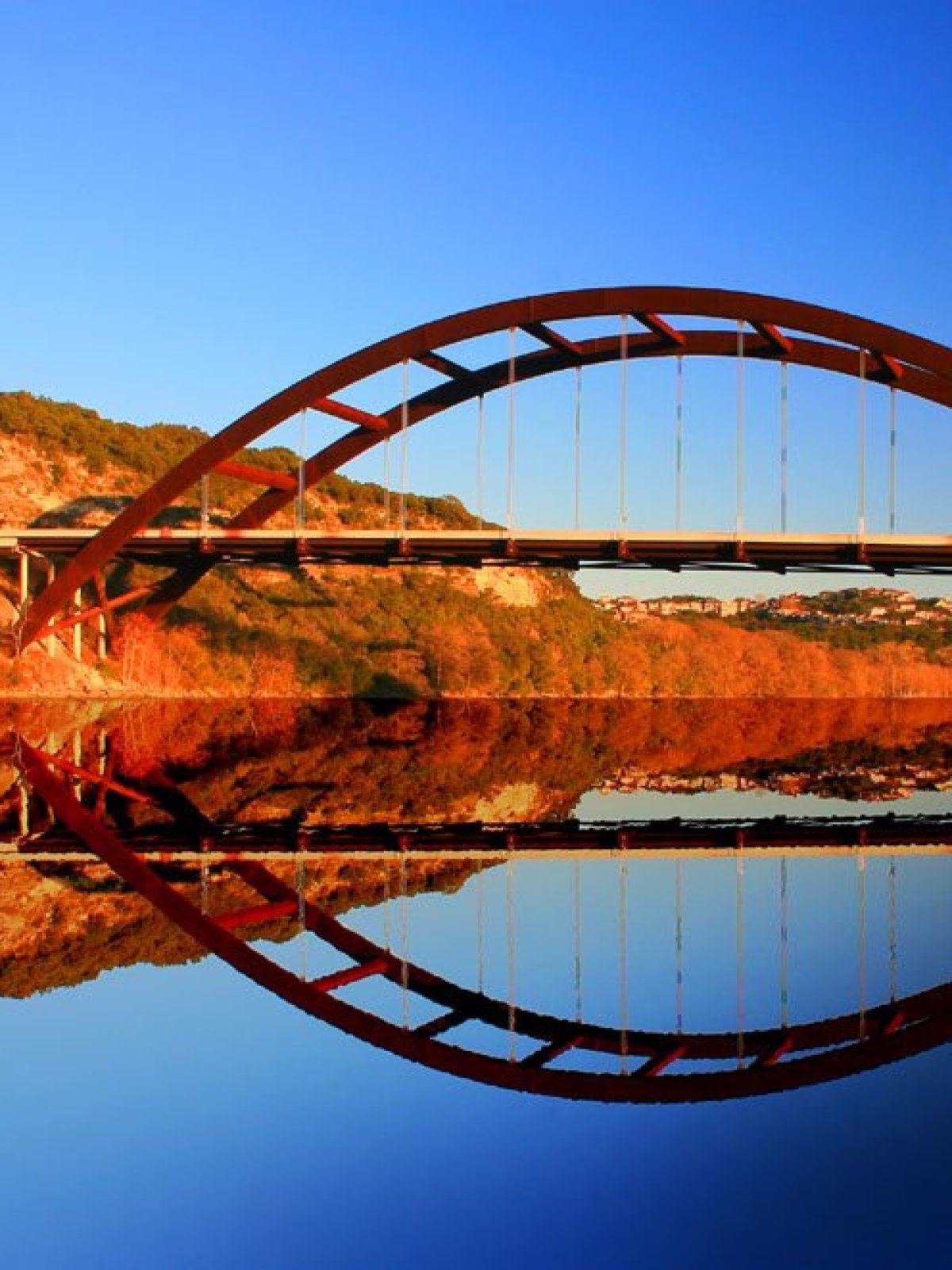 a train crossing a bridge over a body of water