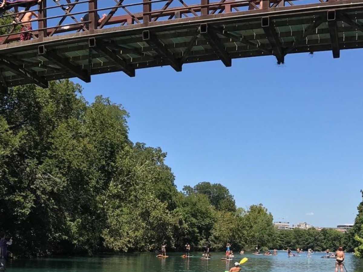 a train crossing a bridge over a body of water