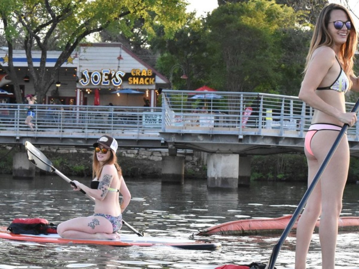 a group of people rowing a boat in the water